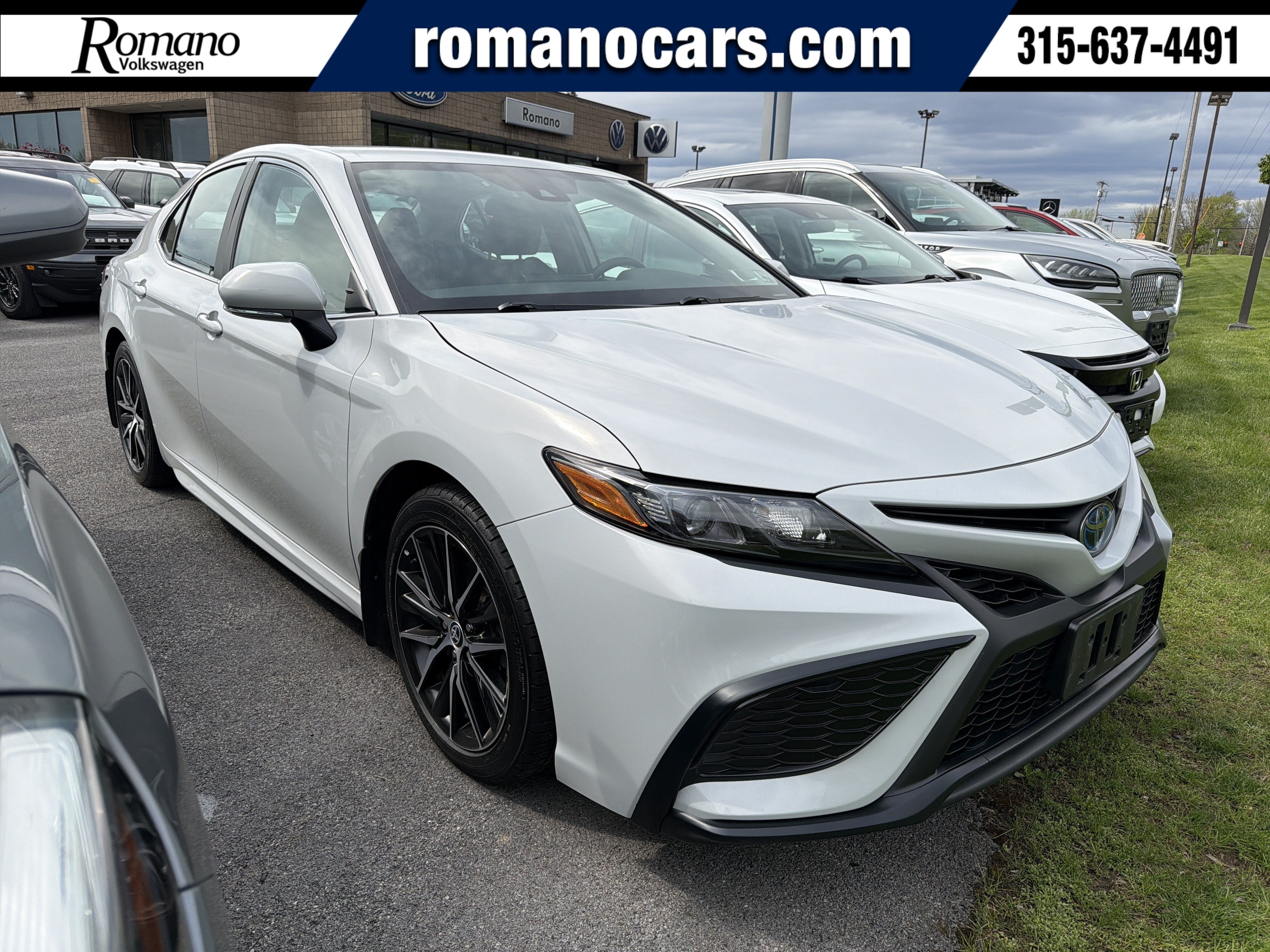 2023 Toyota Camry Hybrid SE in Ice Edge — front three-quarter view
